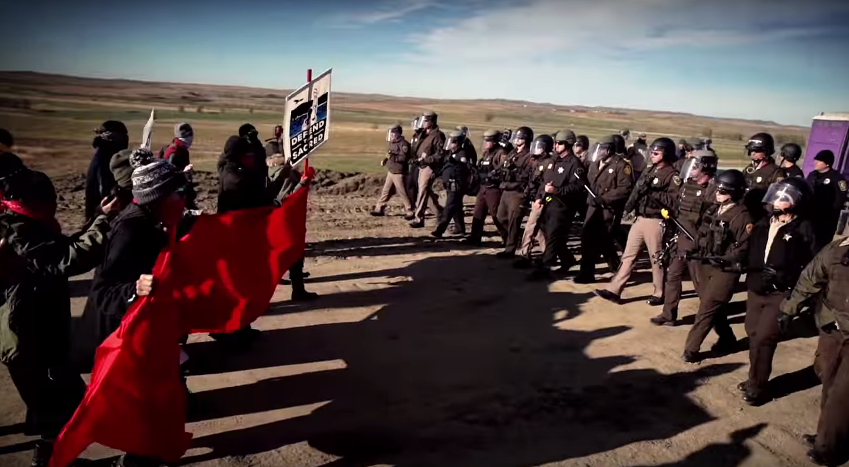 Still from the Music Video Stand Up/ Stand N Rock #NoDAPL, directed by Johnny Lee