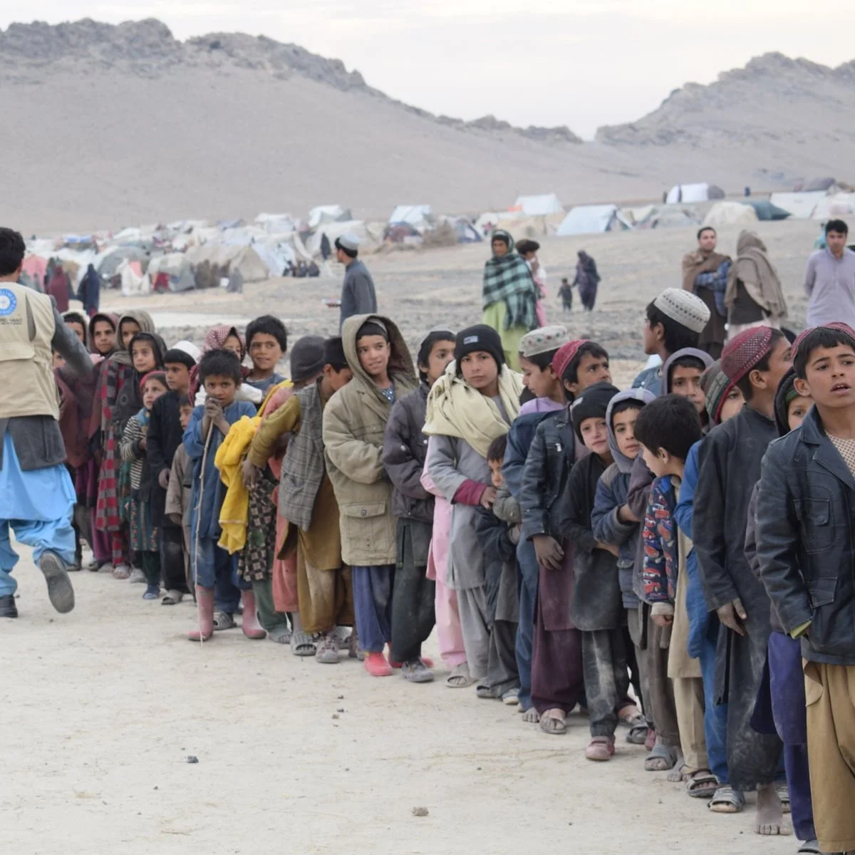  Children wait in line for LHI school packs to be distributed in Afghanistan. 