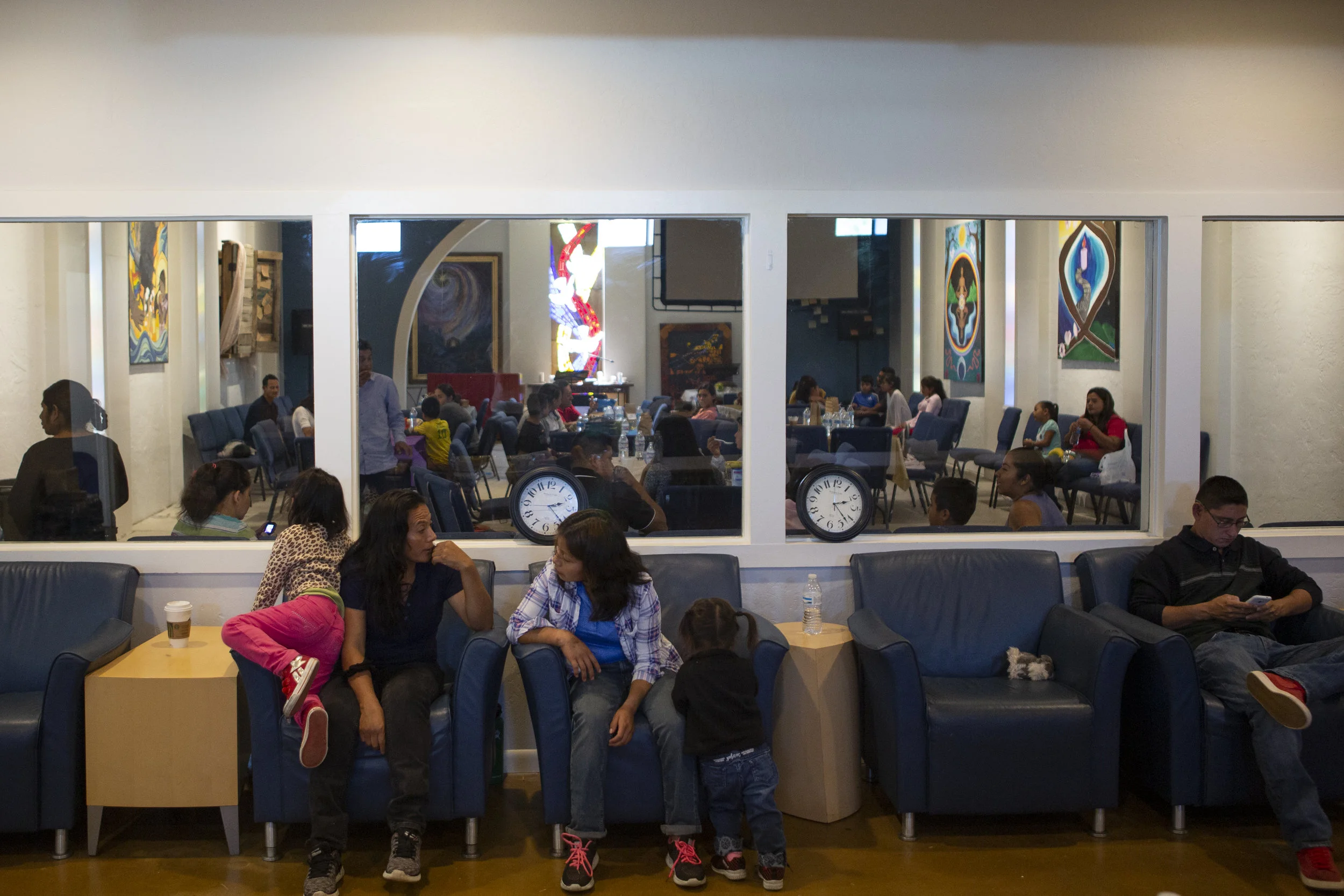 Asylum seekers freshly released from border detention centers wait for travel arrangements to be made for continued journeys to scattered U.S. destinations.