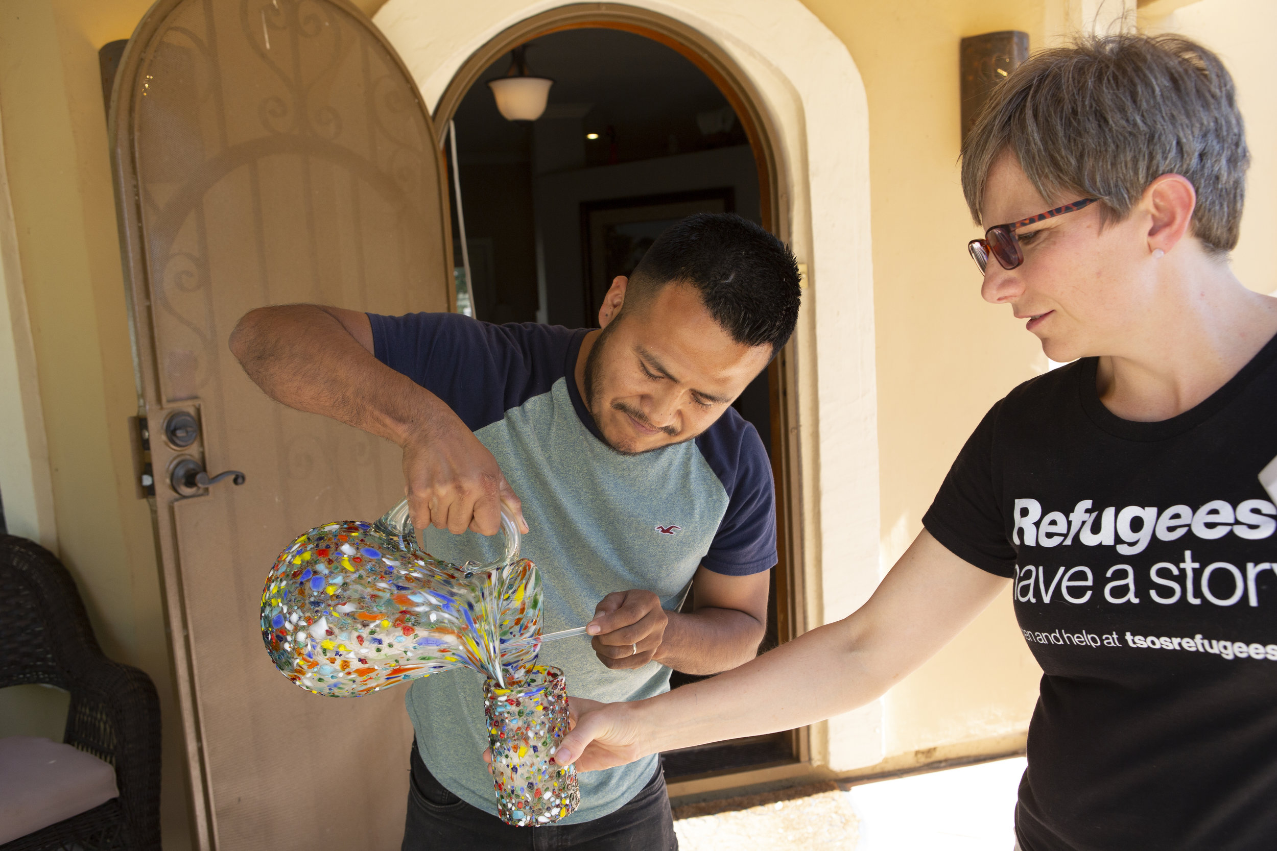   Israel pours lemonade for Megan Carson, from Their Story Is Our Story, when she interviewed him at his Arizona home.  
