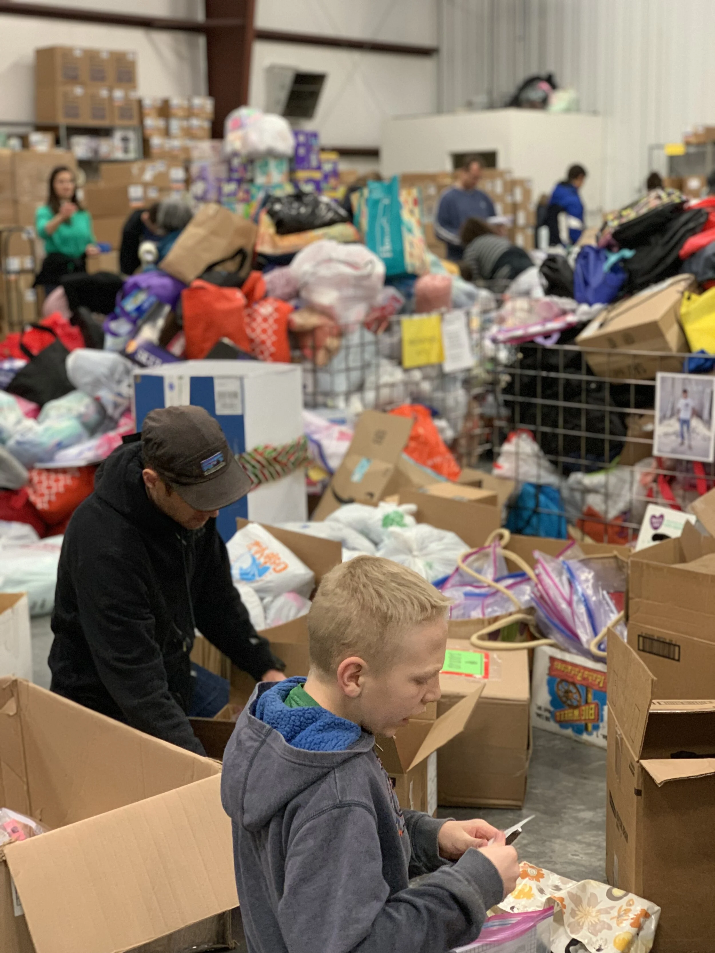  Volunteers sort through donated items in preparation for a shipment. 