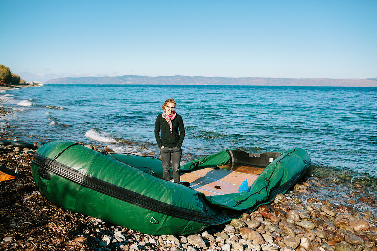   LHI Founder/Director Hayley Smith stands in an abandoned dinghy that likely carried 40–50 refugees across the Aegean Sea from Turkey to Greece.  