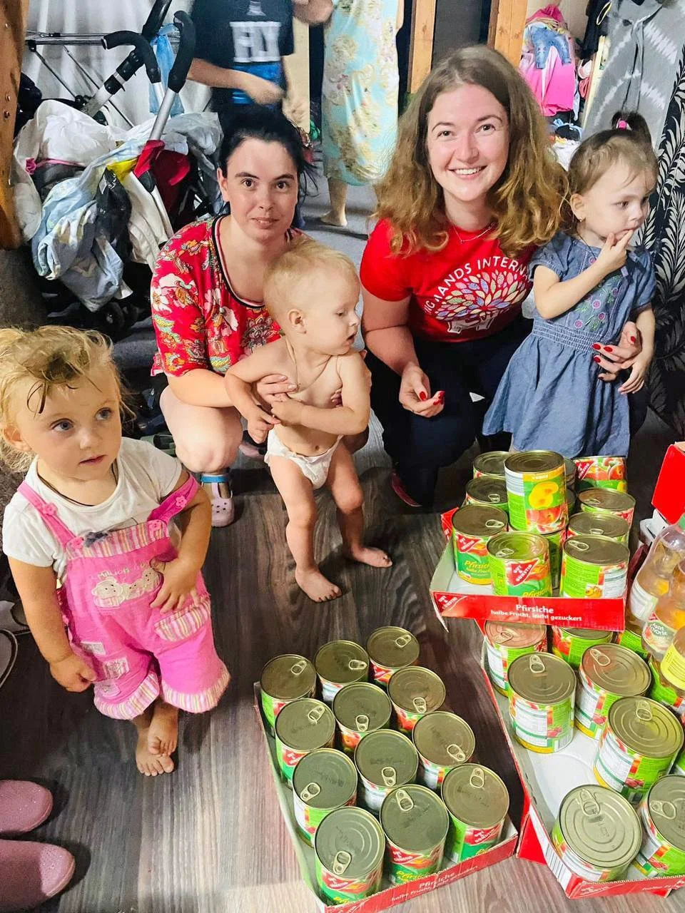  Liza, right, distributes aid at the LHI Shelter in Lviv, Ukraine. 