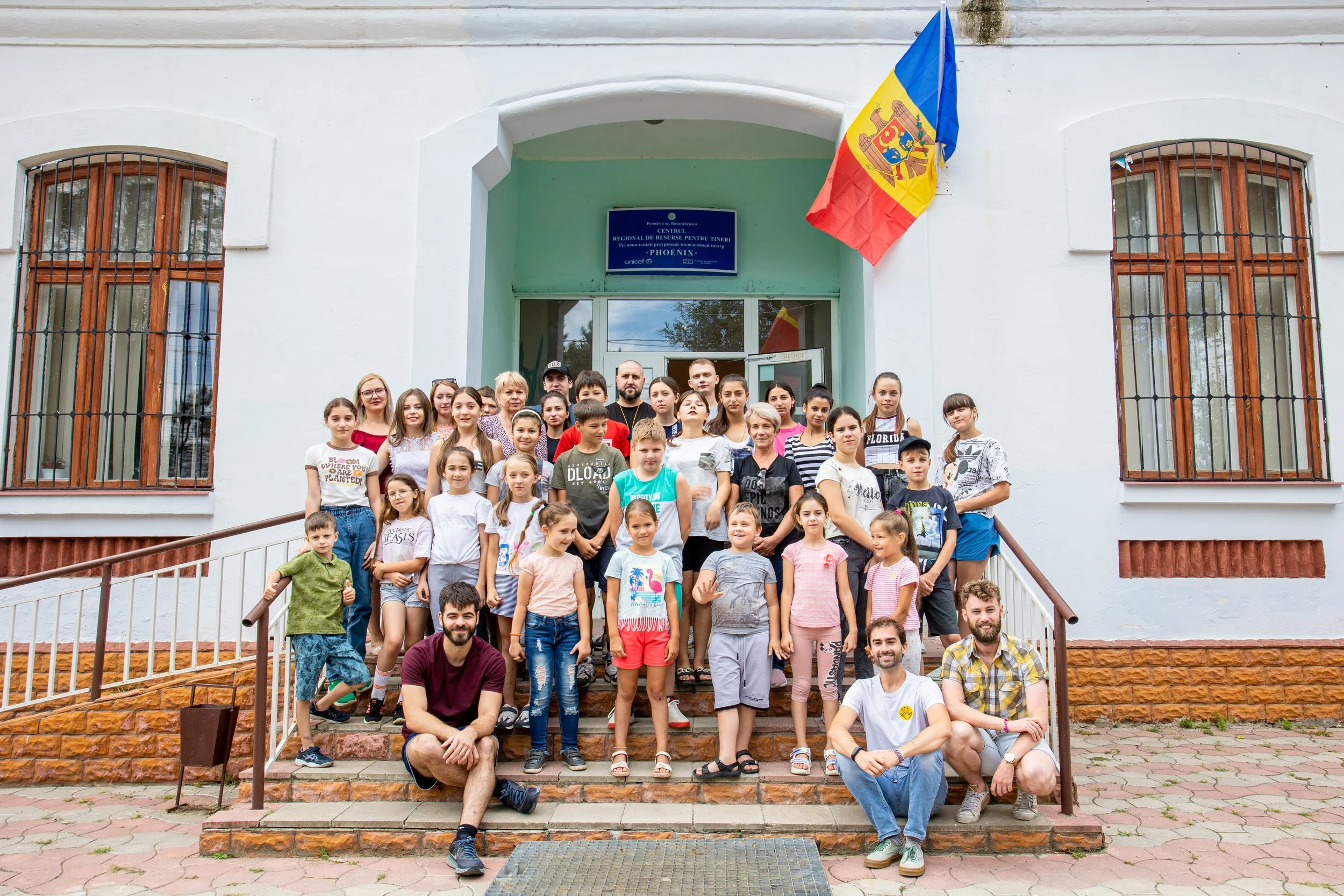  Davide, Thomas, and Edu pose for a group photo outside the Phoenix Center with the campers who made their summer unforgettable! 