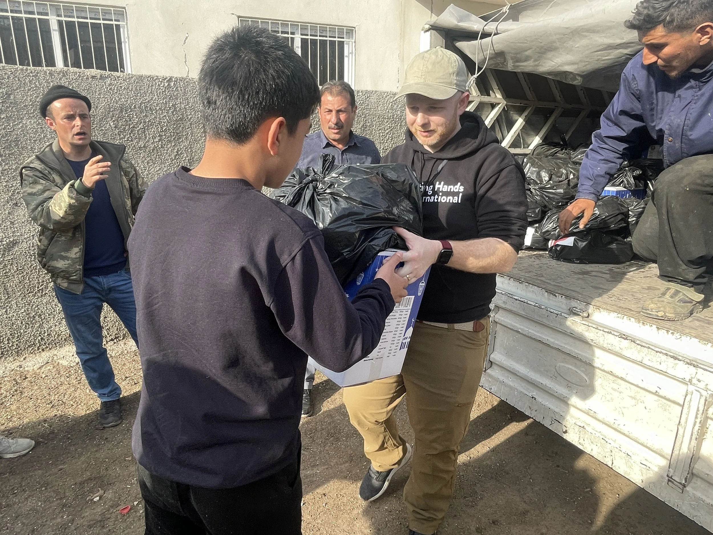  LHI's COO Walker distributed aid to an earthquake survivor in Turkey. 