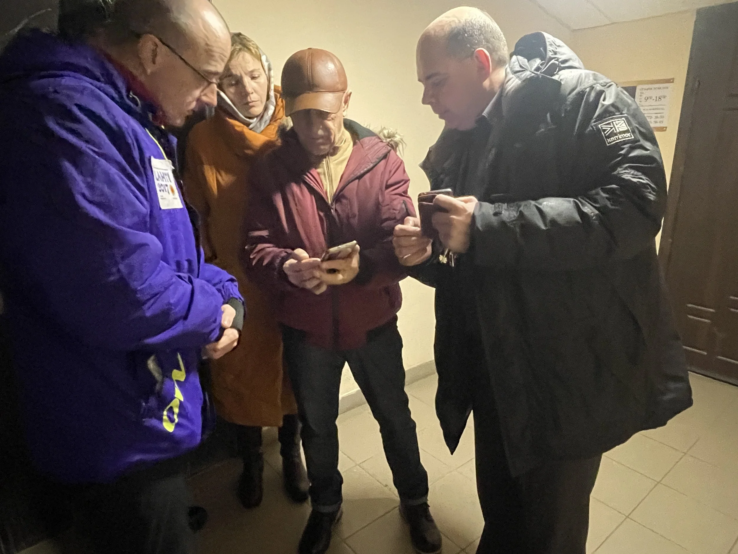  The team of two friends on the right survived the occupation. They showed us pictures of the damage to an apartment block that they are now repairing. 