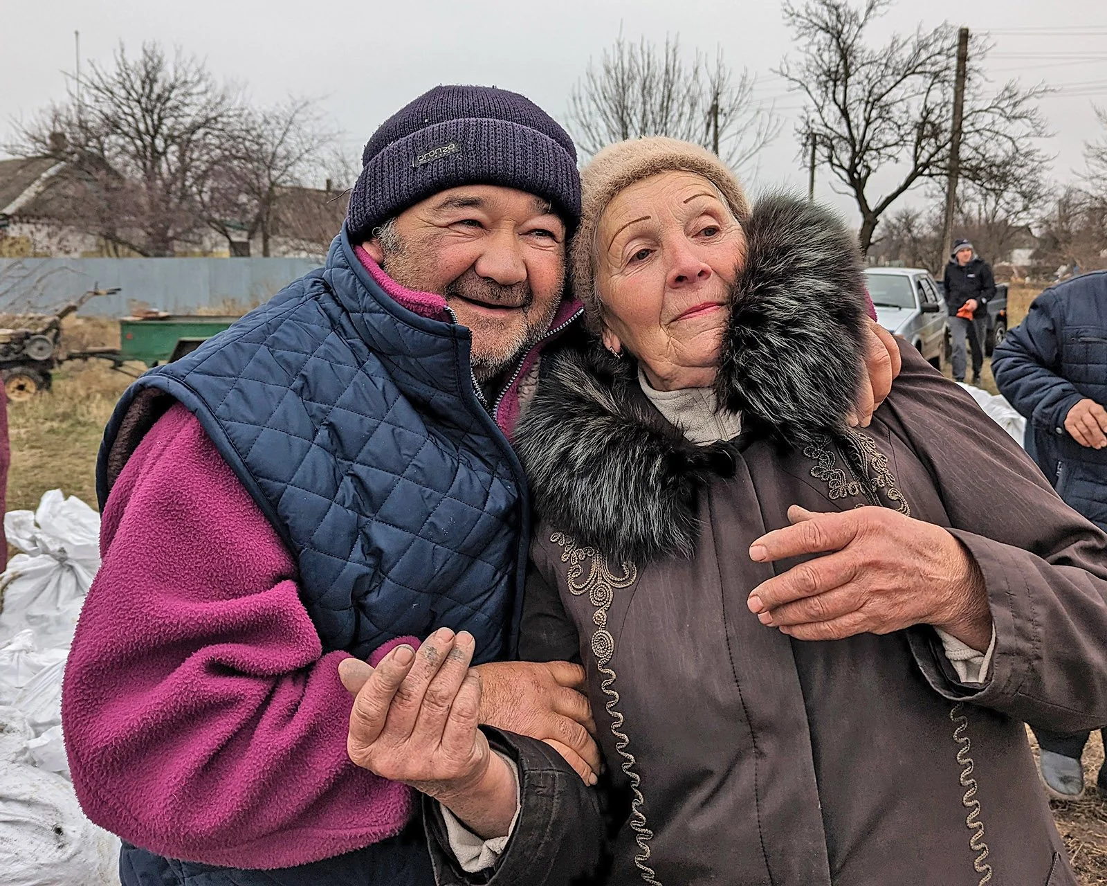  Two family members during a distribution of coal and winter clothes for Myrne village, Donetsk region. 