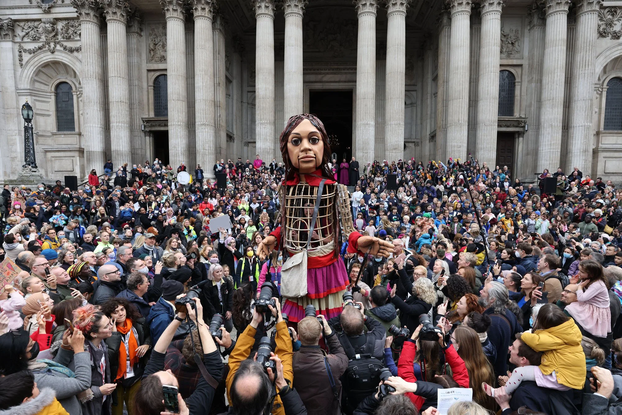  Meet Little Amal, a 12 foot tall puppet of a 10 year old Syrian refugee. Here, she is welcomed in London in 2021 after completing a 5,000 mile journey across Europe. I’m excited to welcome her to my hometown in a week! 