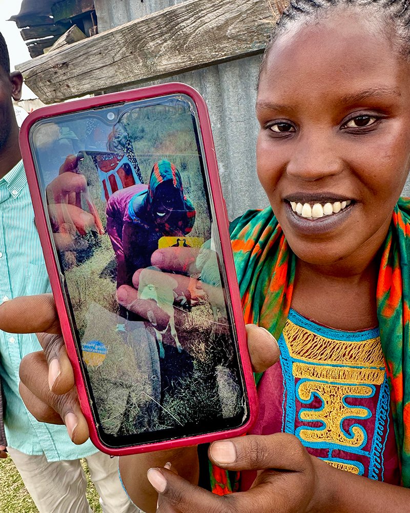  Asa smiling whilst showing us a photo of her new goat. 