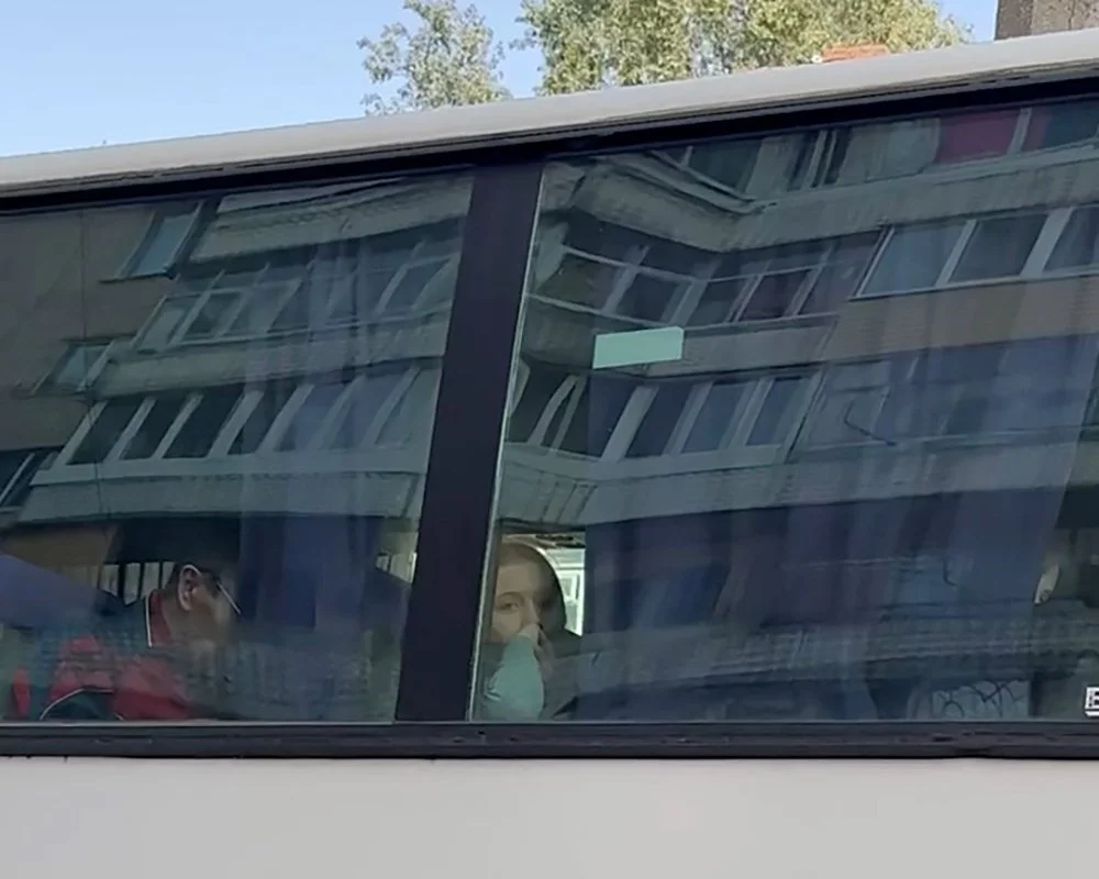  A girl waits for the bus to depart. 
