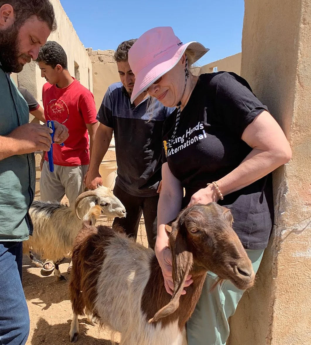  While in Jordan, Mary (pictured in a pink hat) helped inspect each goat to be distributed. 