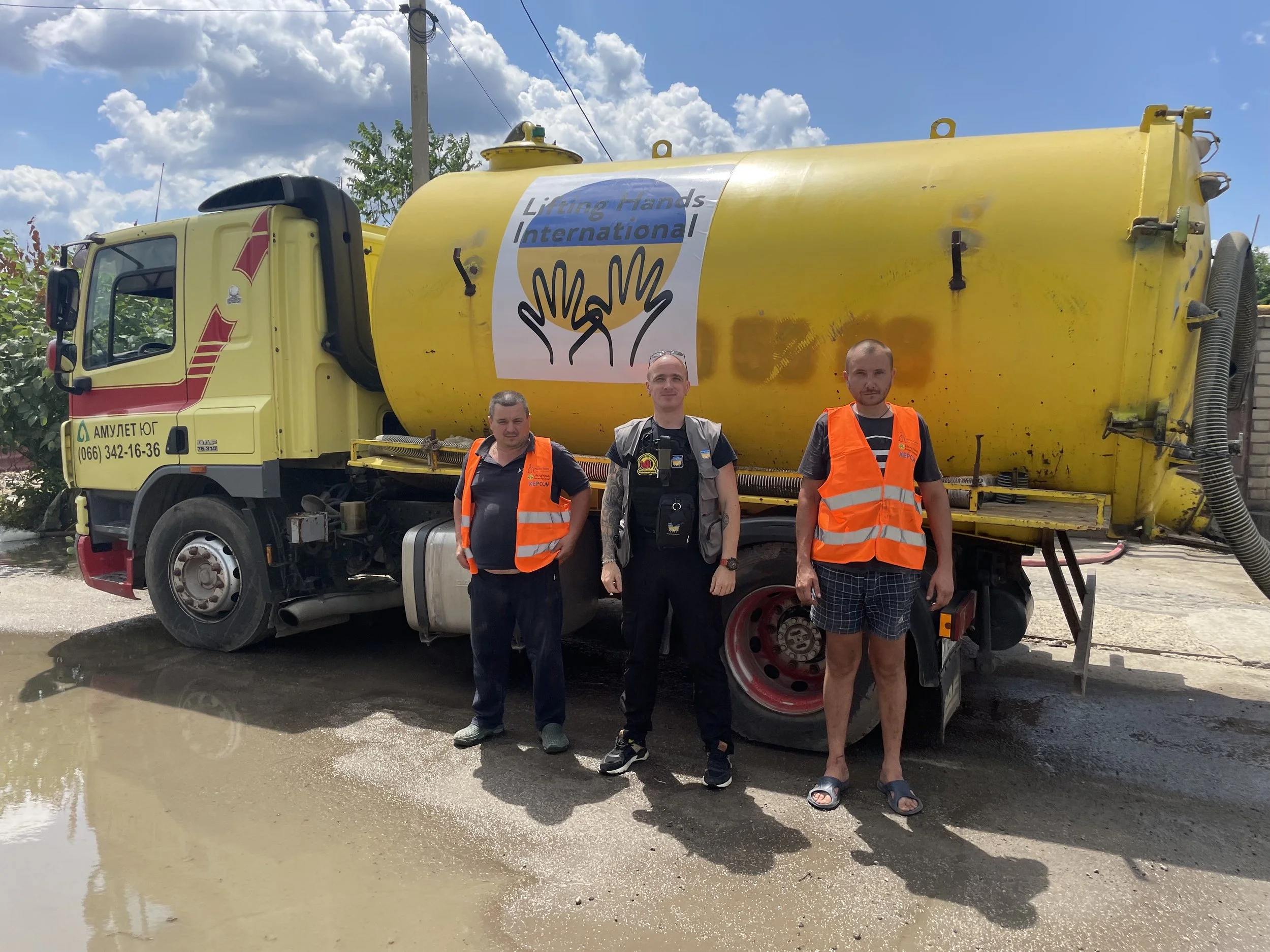  LHI's Ukraine country director Serhii (center) organized LHI's response to the dam collapse, including finding this truck which pumped thousands of tons of water out of homes and businesses. 