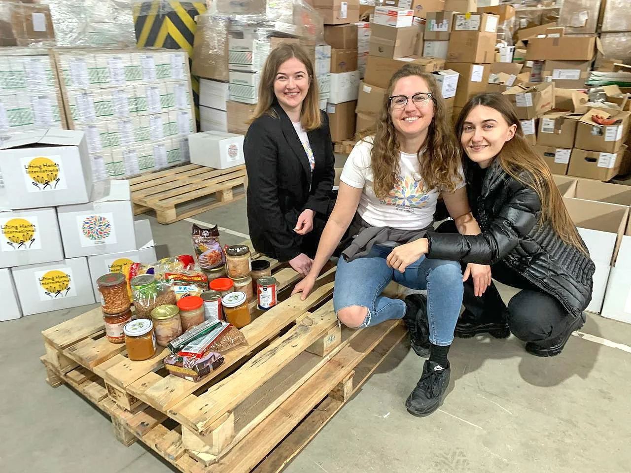  Liza, left, oversees the LHI/I Am Not Alone food box program. We visited their warehouse back in April and got to see the program in action.  