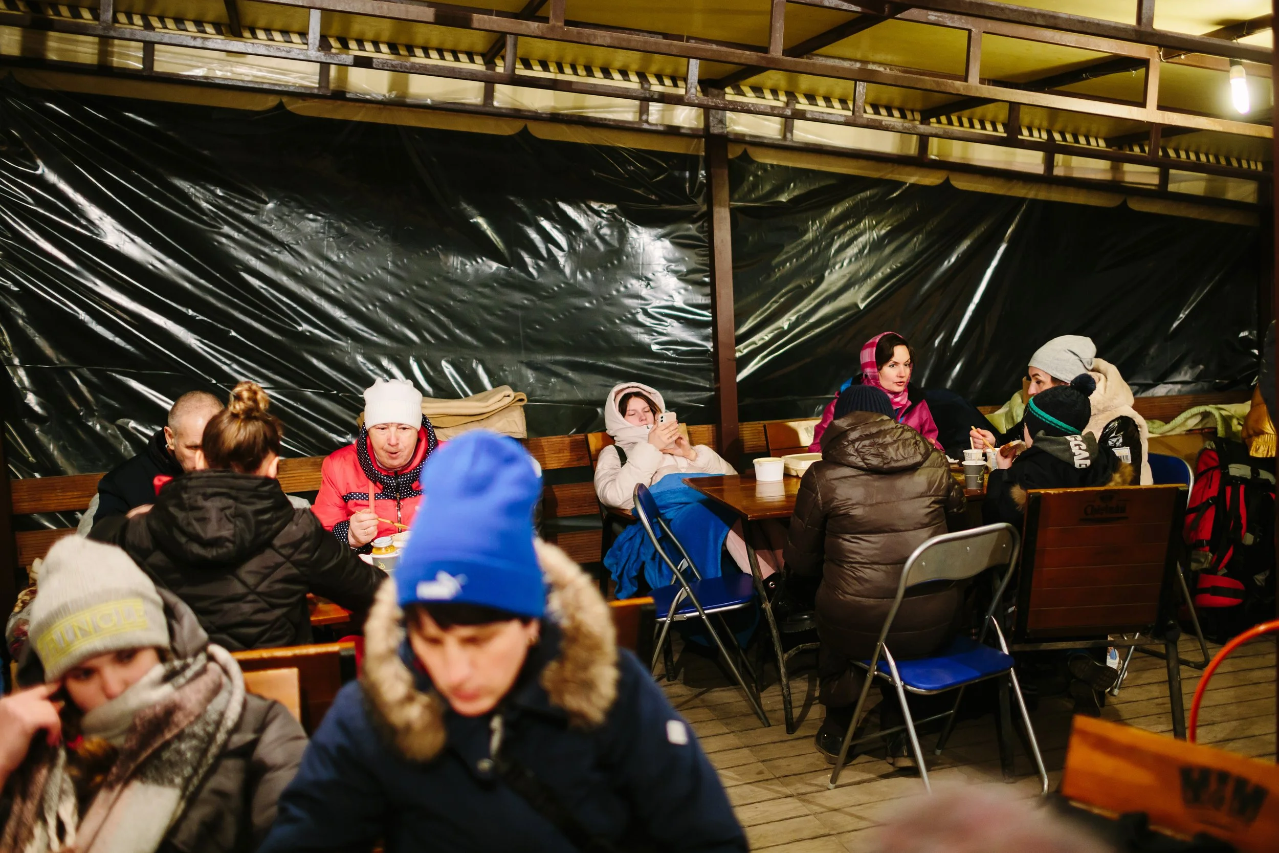  Ukrainians stop for a hot meal on the border of Moldova and Ukraine. This tent is warmed by a generator, a resource desperately needed throughout Ukraine this winter. 