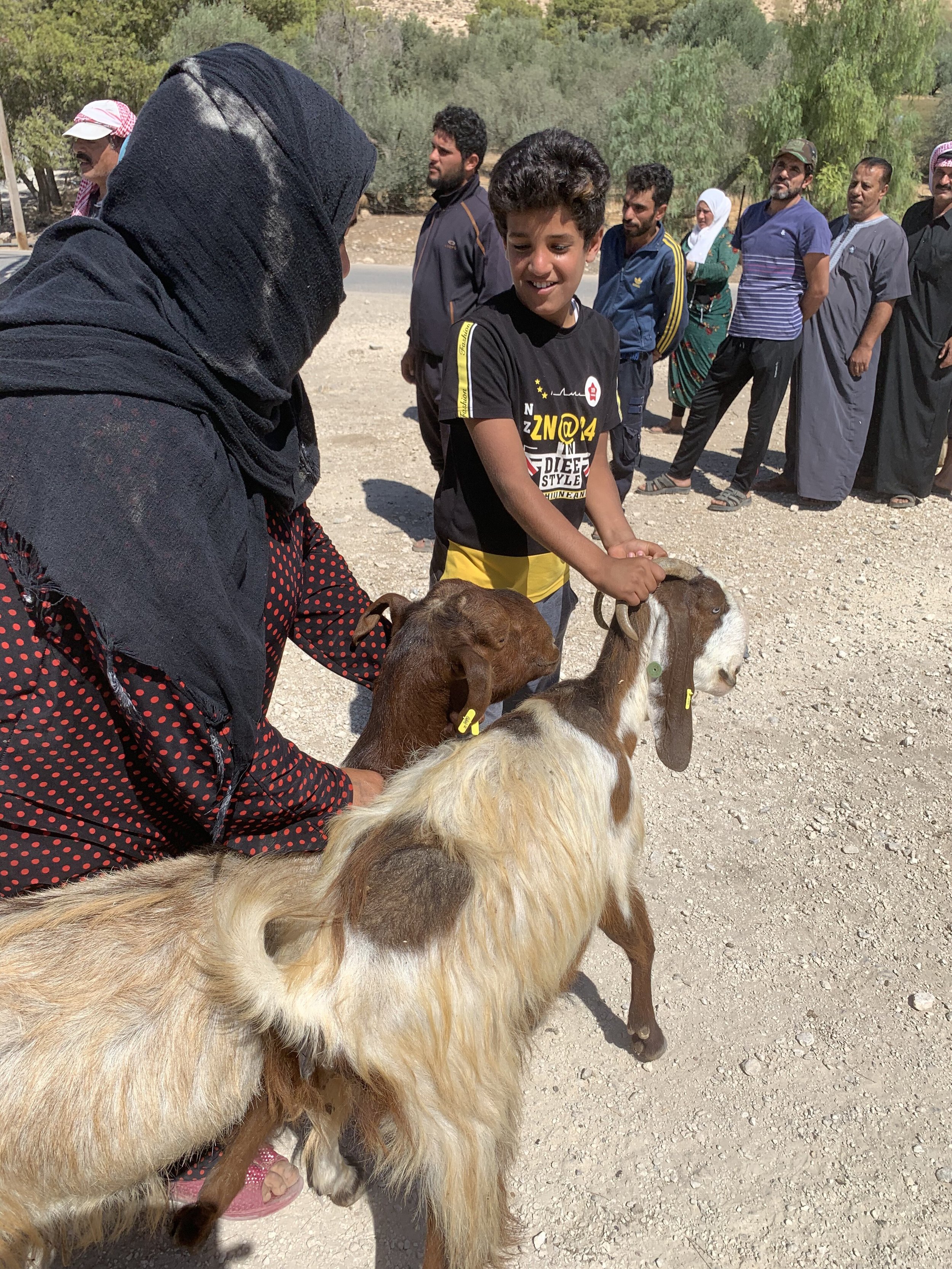  A strong Syrian mama and her family welcome their two new milk goats courtesy of our generous donors! Madaba, Jordan. 