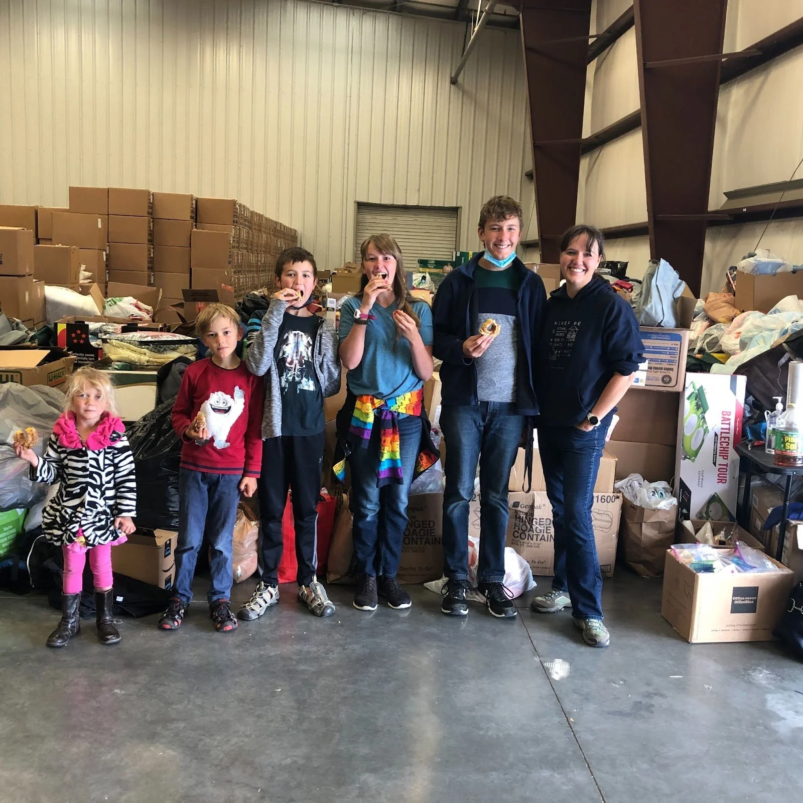  The Stanfill family, Lark, Van, Zane, Zoe, Jed, Vanessa, enjoy a treat while volunteering at the LHI Humanitarian Aid Warehouse. 