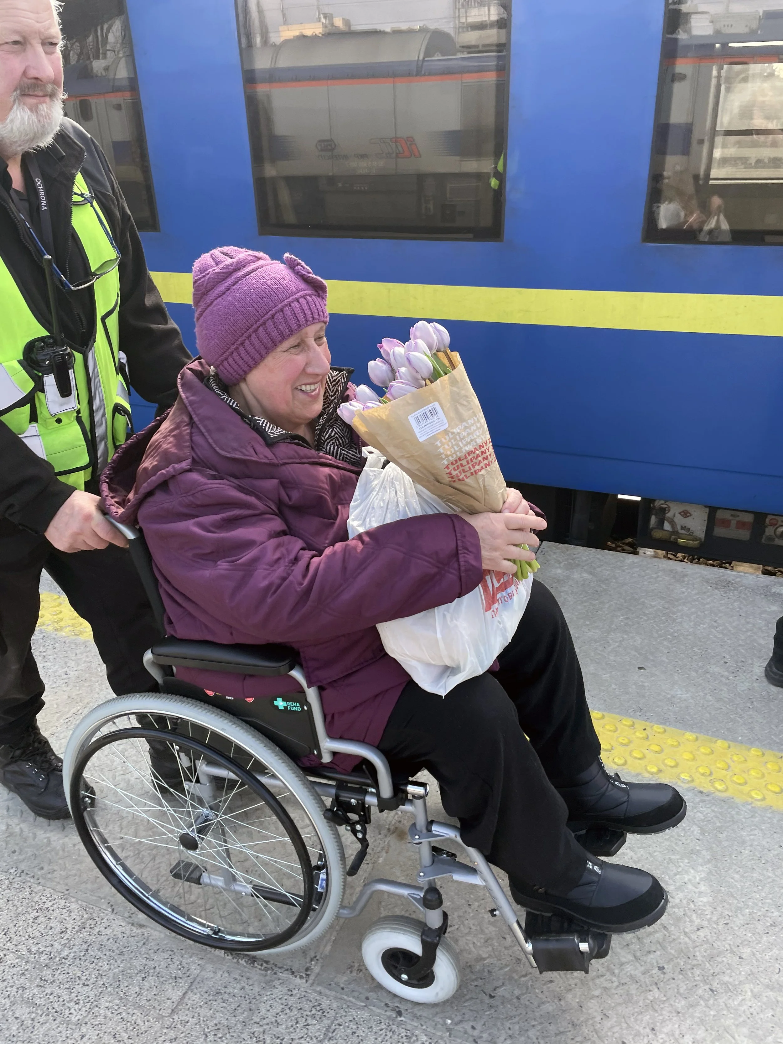   Riya after being rescued from her 9th floor apartment in Ukraine receives help at the Warsaw Central Station on her journey to Utah.&nbsp;  