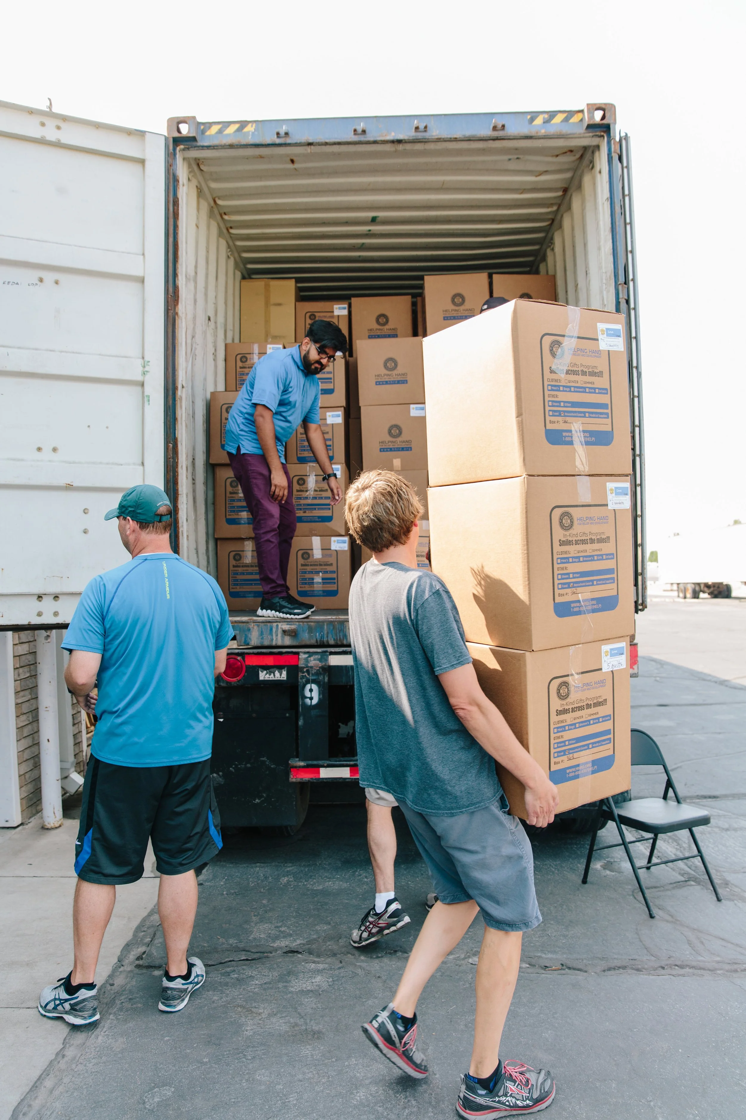  LHI Volunteers load a container of international aid 