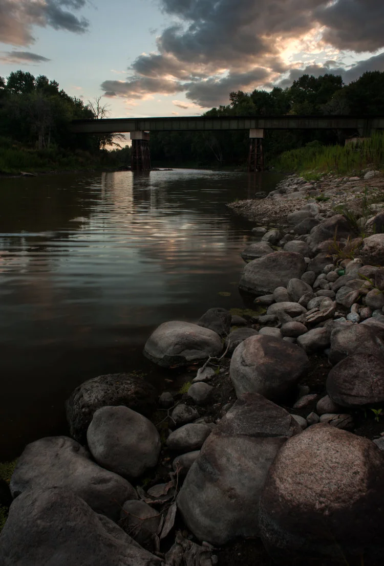 Rocks on the St Norbert river are shown in this landscape photograph.