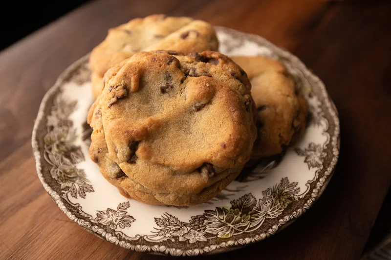 Three cookies on a small plate. © Robert Lowdon