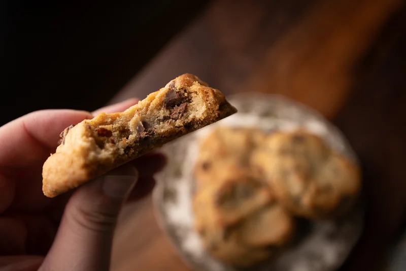 Hand holding the cookie. © Robert Lowdon