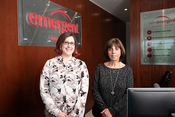 Two staff members at the front counter