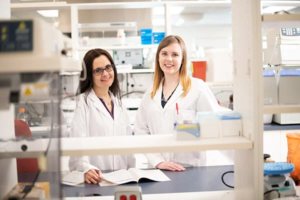 Two lab technicians pose for a casual photograph