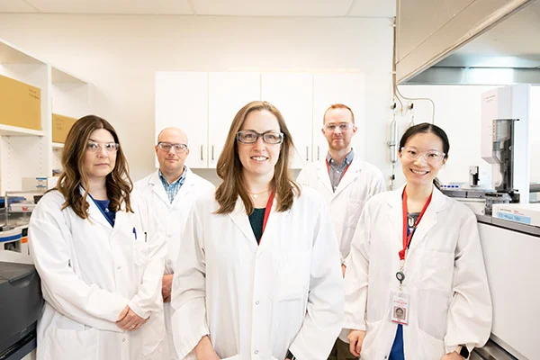 Workers pose in a laboratory