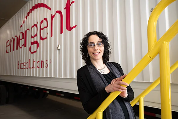 A casual portrait in front of a mobile laboratory.