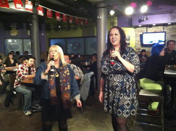 Brandon University President Dr. Deborah Poff, and BUSU President Carissa Taylor take part in karaoke at SUDS during Snowientation. (Jenna Clinton / BUSU)