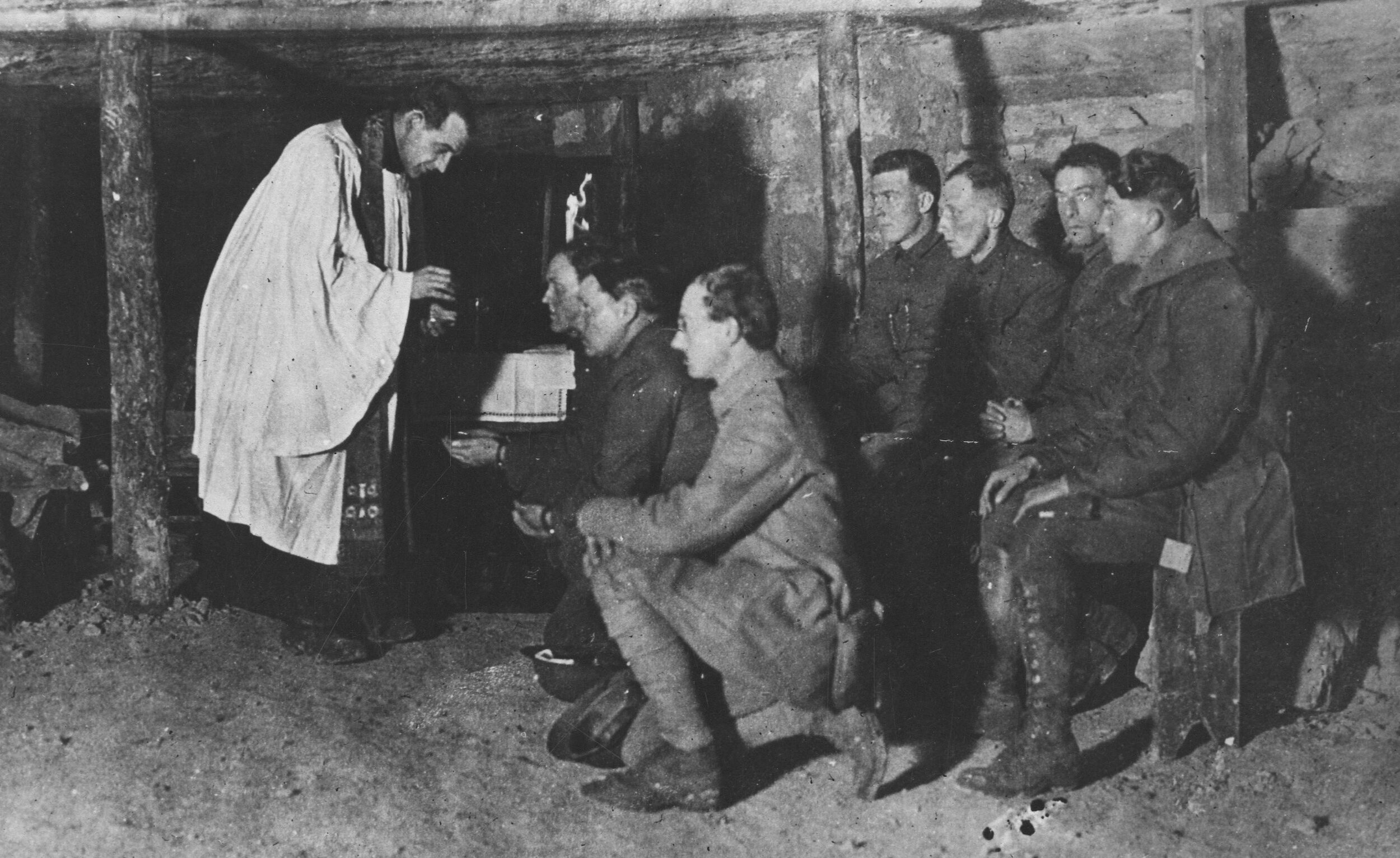 American Episcopalian Priest Lyman Rollins administers Eucharist in a dug-out