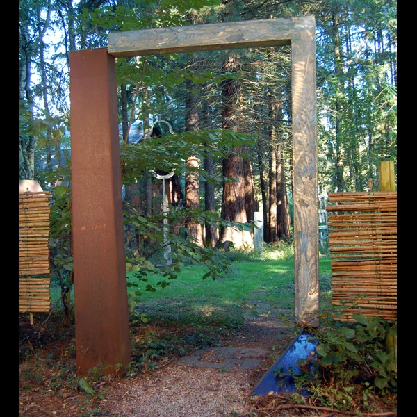 Borrowed Landscape Mild steel, stainless steel and porcelain enamel gate with wooden fence. Sited at Leland Iron Works.