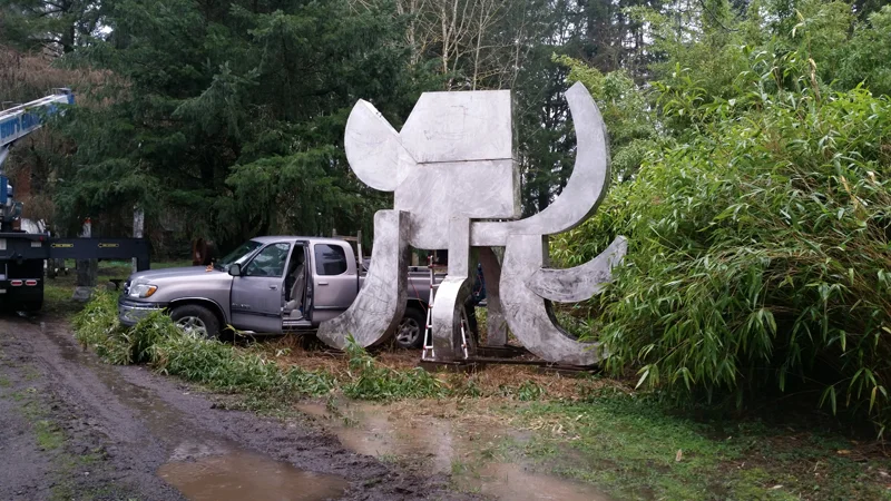 The crew starting the task of disassembling Akbar's Elephant from the site it occupied since 2000. Notice the lake of brown water under the sculpture. Oregon received more than twice the amount of rainfall that normally falls in February, and most of it came down that day.