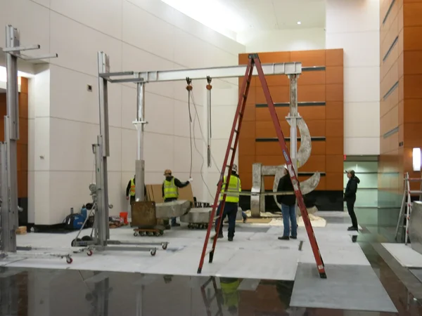 Here is the gantry crane assembled about to be moved into position. In the background you can see parts of the sculpture. Photo by Lee Kelly.