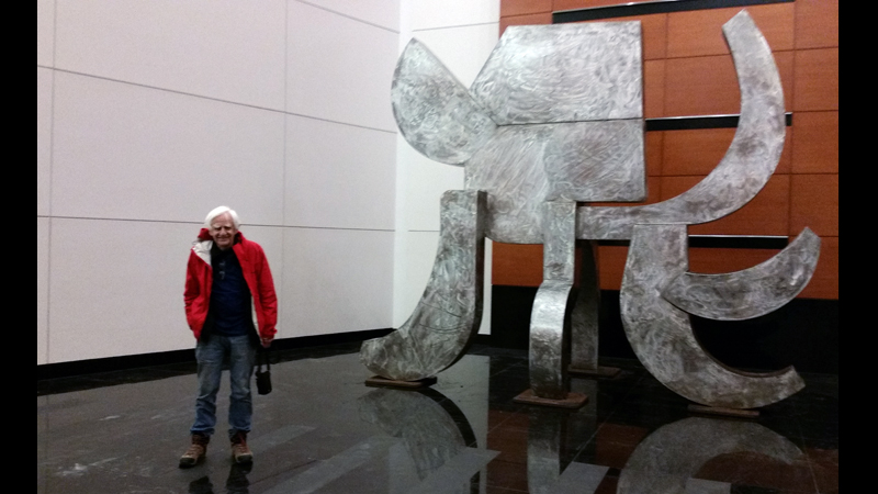 The artist and the elephant in the Fox Tower lobby, afternoon of the installation.