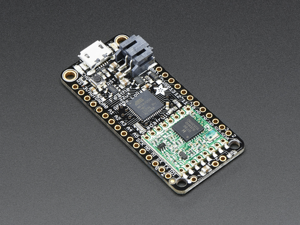 - ADAFRUIT FEATHER 32u4 RFM95 LoRa Radio - 915 MHzThis new development board is roughly the same length and width of the ProTrinket, and comes with built-in LoRa transmission capabilities as well as a place to solder in a ufl connector. The Feather also includes a portable battery attachment which we will be using for our power source