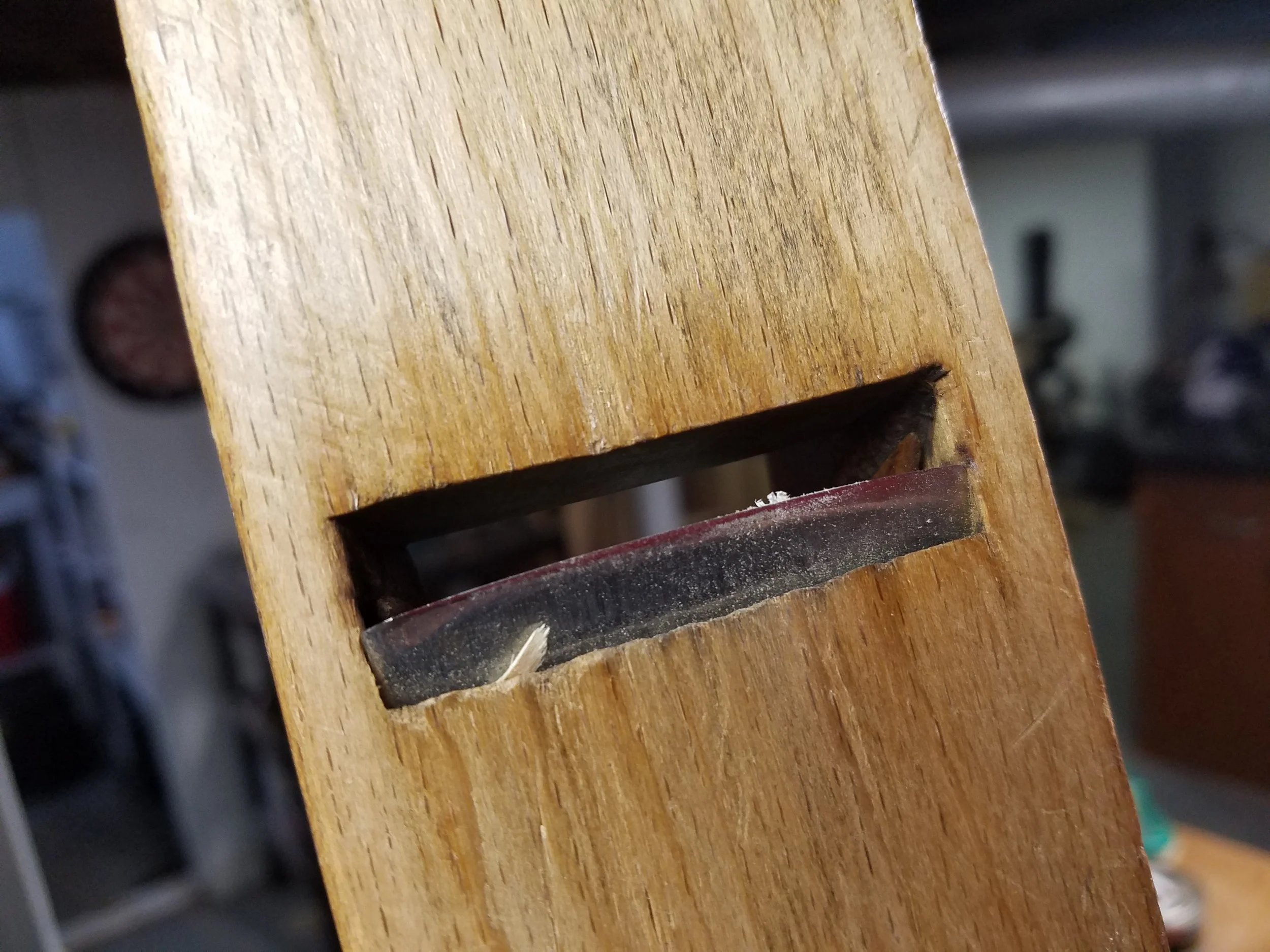 The cambered iron of a fore plane. This is a wooden one, but you get the idea.