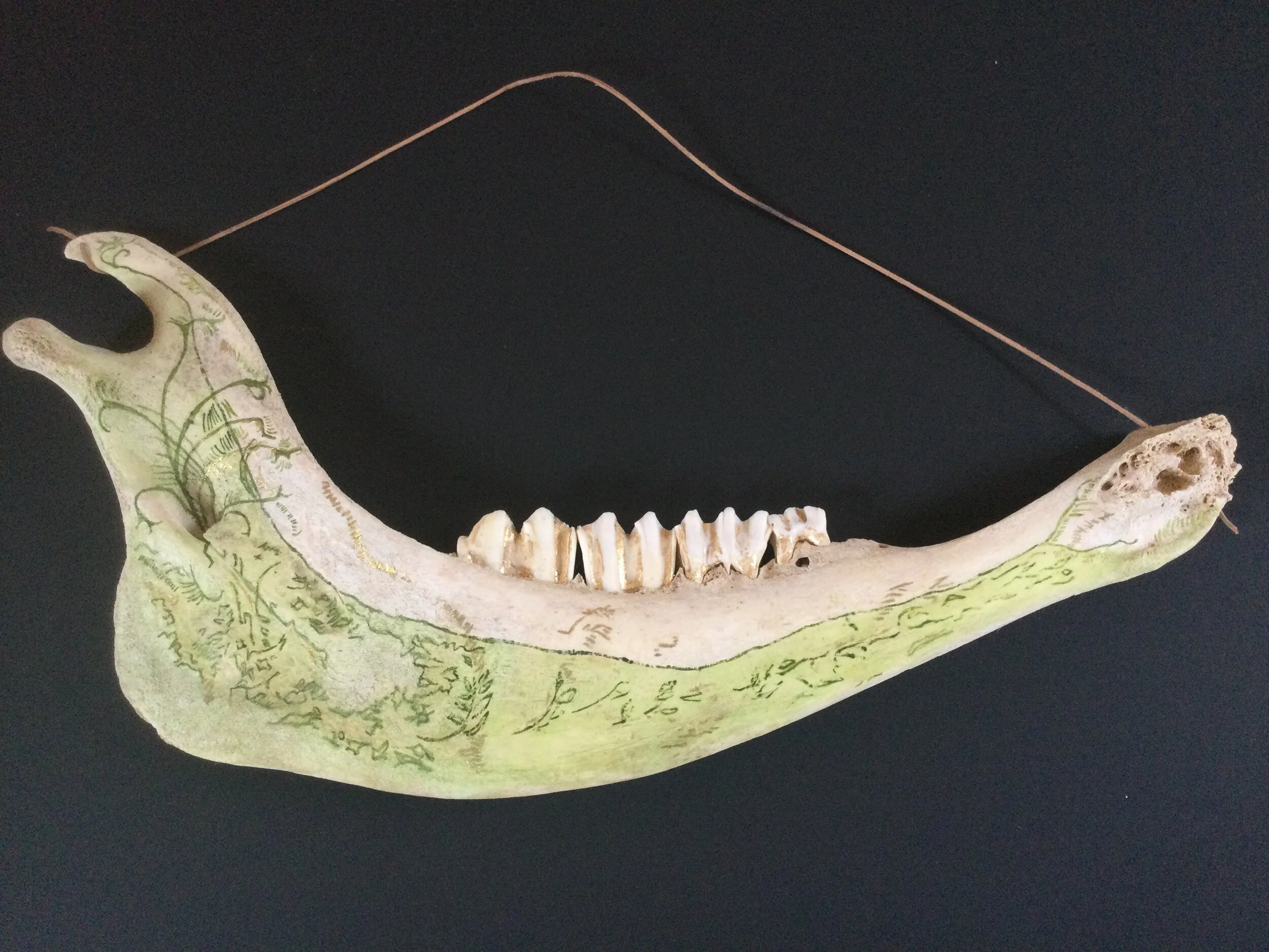 Wall hanging, bone with green ink and gold leaf