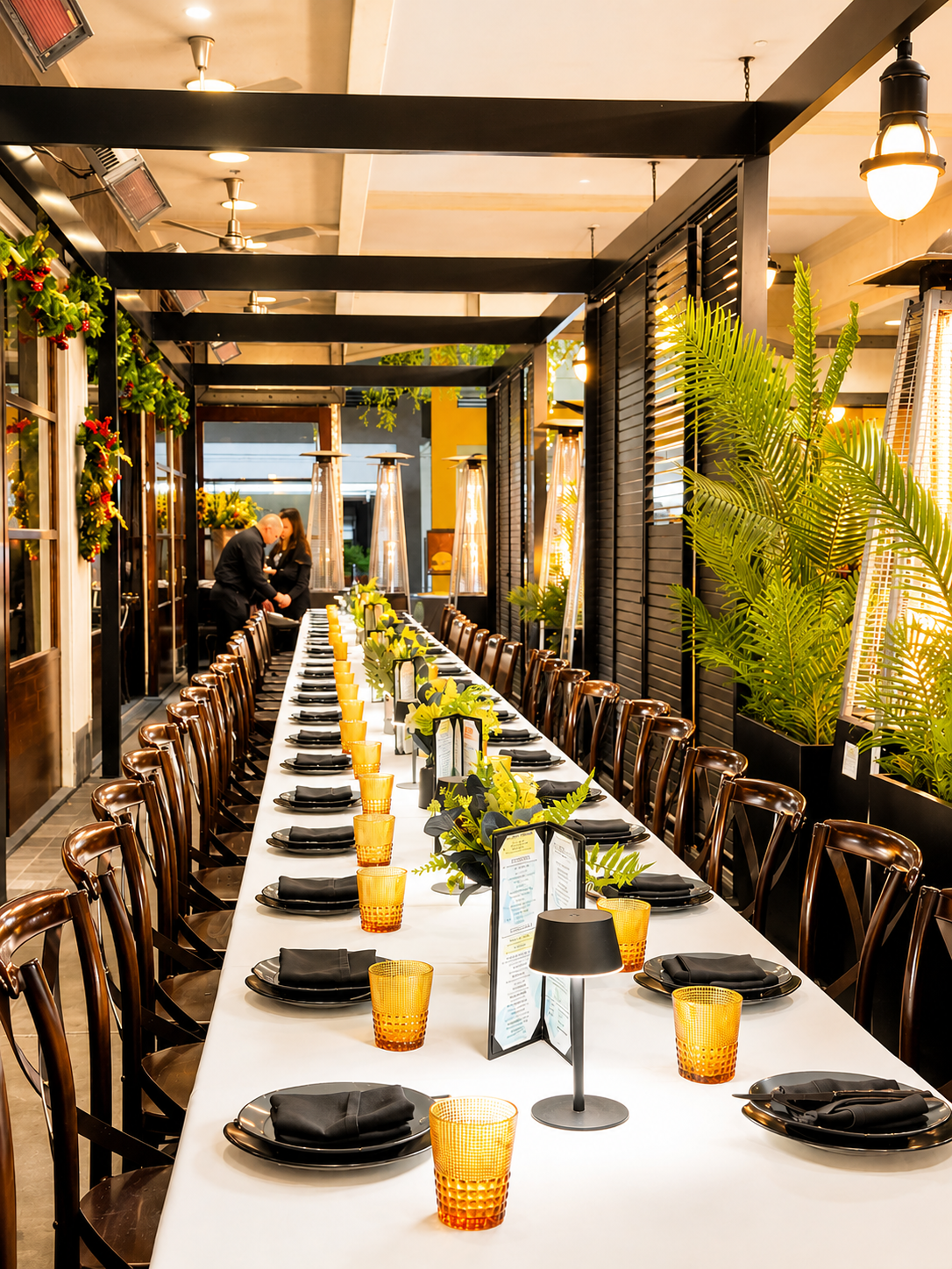 Elegant banquet setup with festive greenery.png