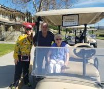 Dorothy in her golf cart and ready to go with son, Fred and Director Ashley Cole.