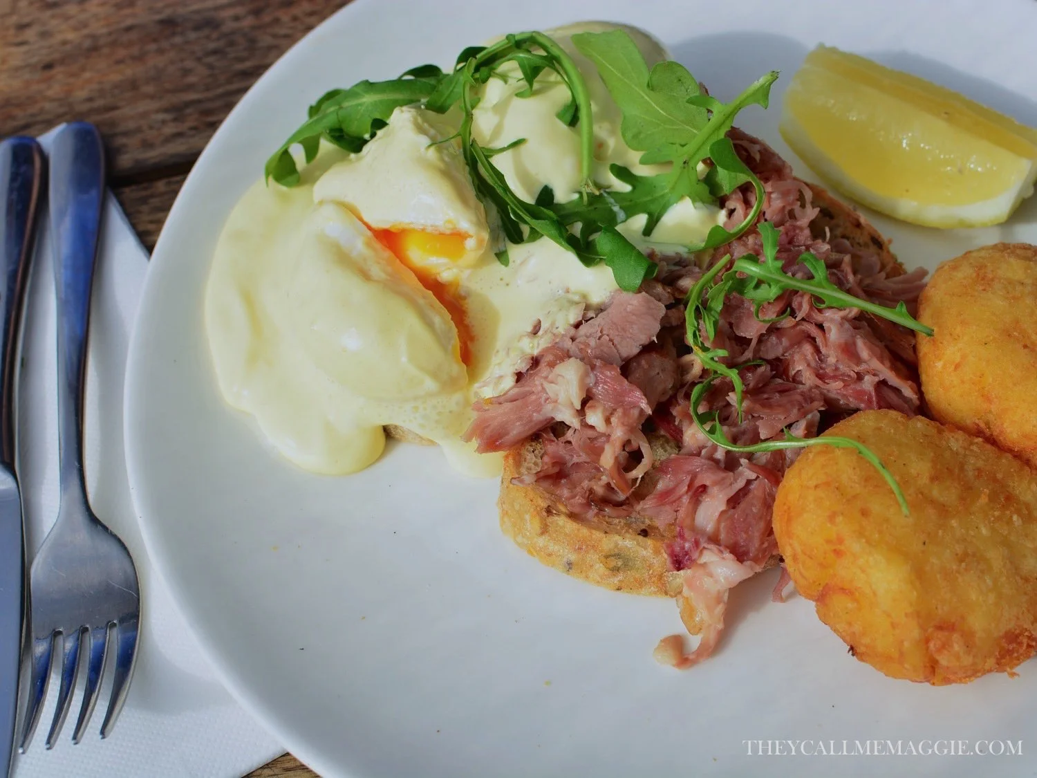 Eggs benedict with pulled ham hock, poached eggs, apple cider hollandaise and potato hash.