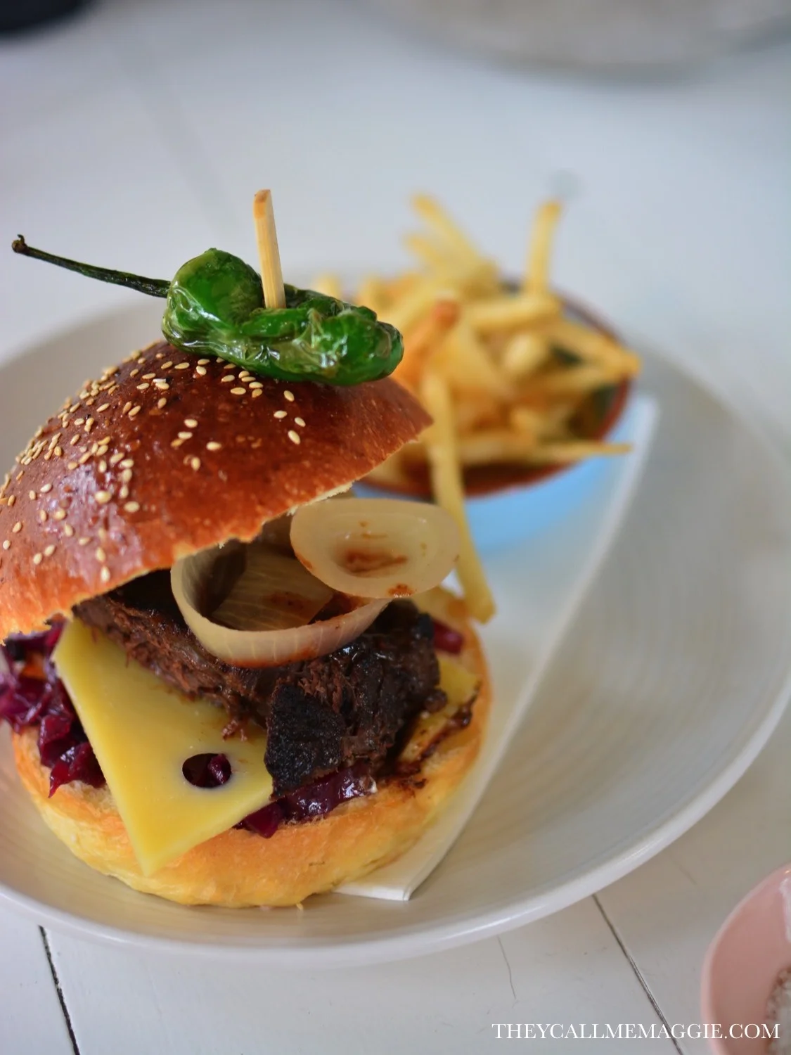 Beef cheek burger - with redkraut, emmantal, pickled onions and side pedron peppers, served with fries. 