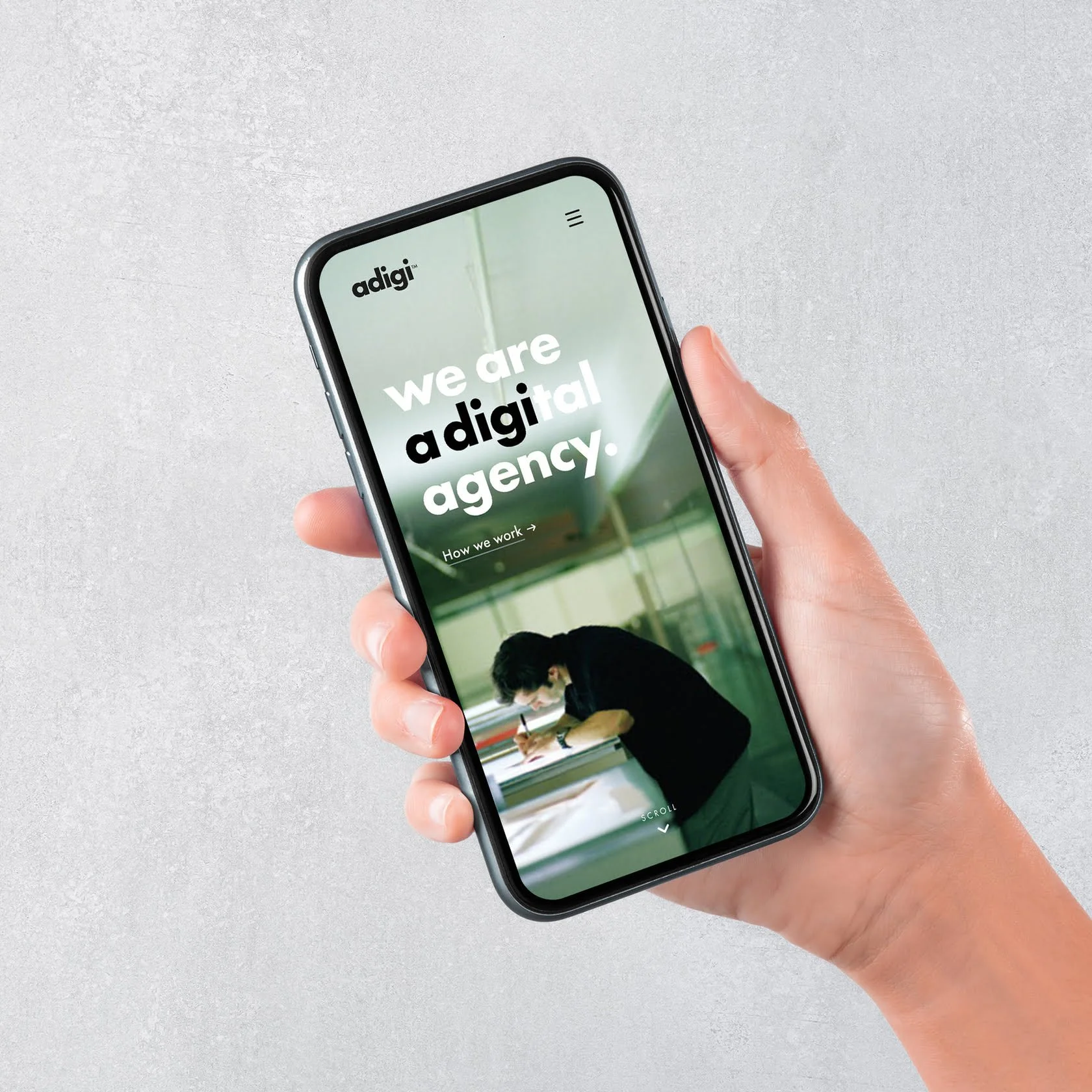 adigi mobile phone in hand displaying website