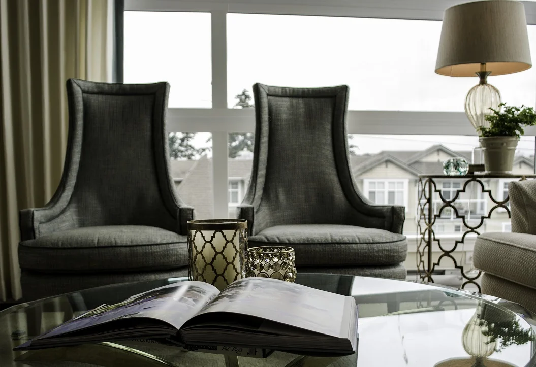AFTER: Living Area - Notice the elegant reupholstered chairs, formerly hidden in a bedroom.