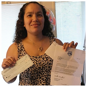 Lidia Flores, the 2016 Florida ACME Wounded Warrior Scholarship recipient, posing with her scholarship and award letter. 