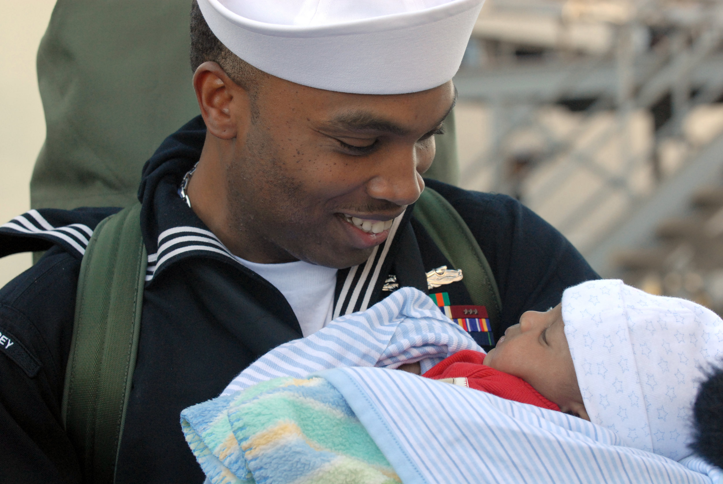 US_Navy_061224-N-9909C-009_A_proud_father_and_Sailor_from_the_destroyer_USS_Halsey_(DDG_97)_holds_his_child_for_the_first_time.jpg