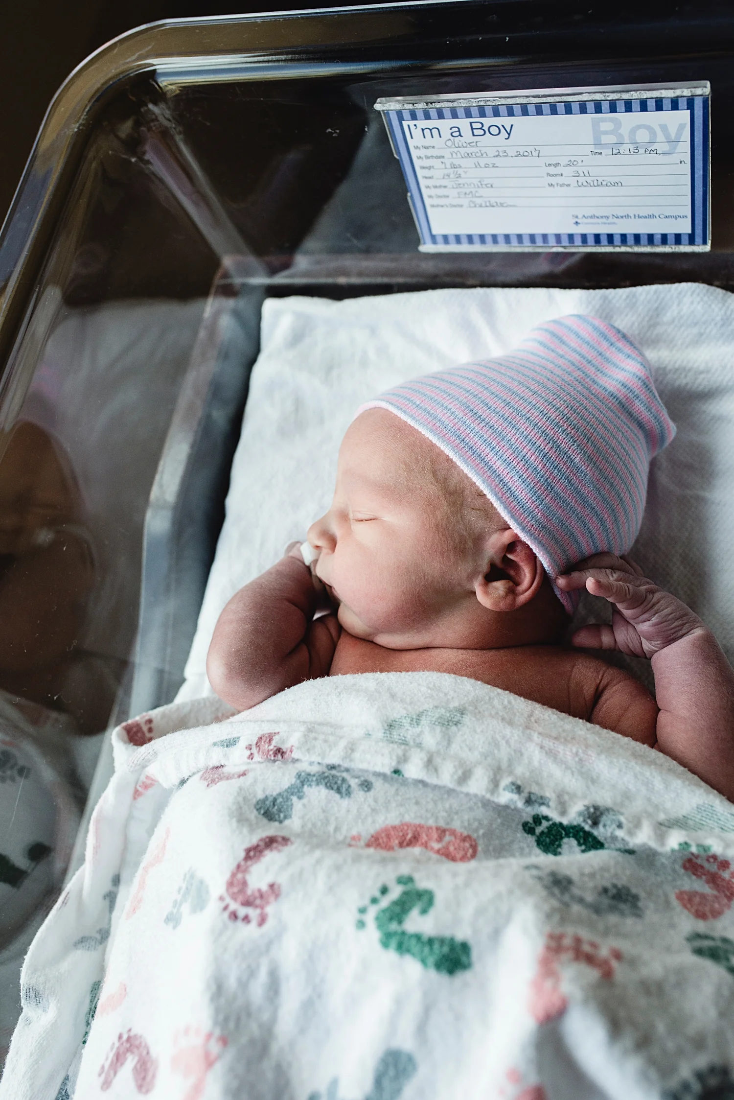 A baby boy in his hospital bassinet with name card during a Fresh 48 newborn photo shoot in Denver, Co. Photo by Kristiina Craven Photography.