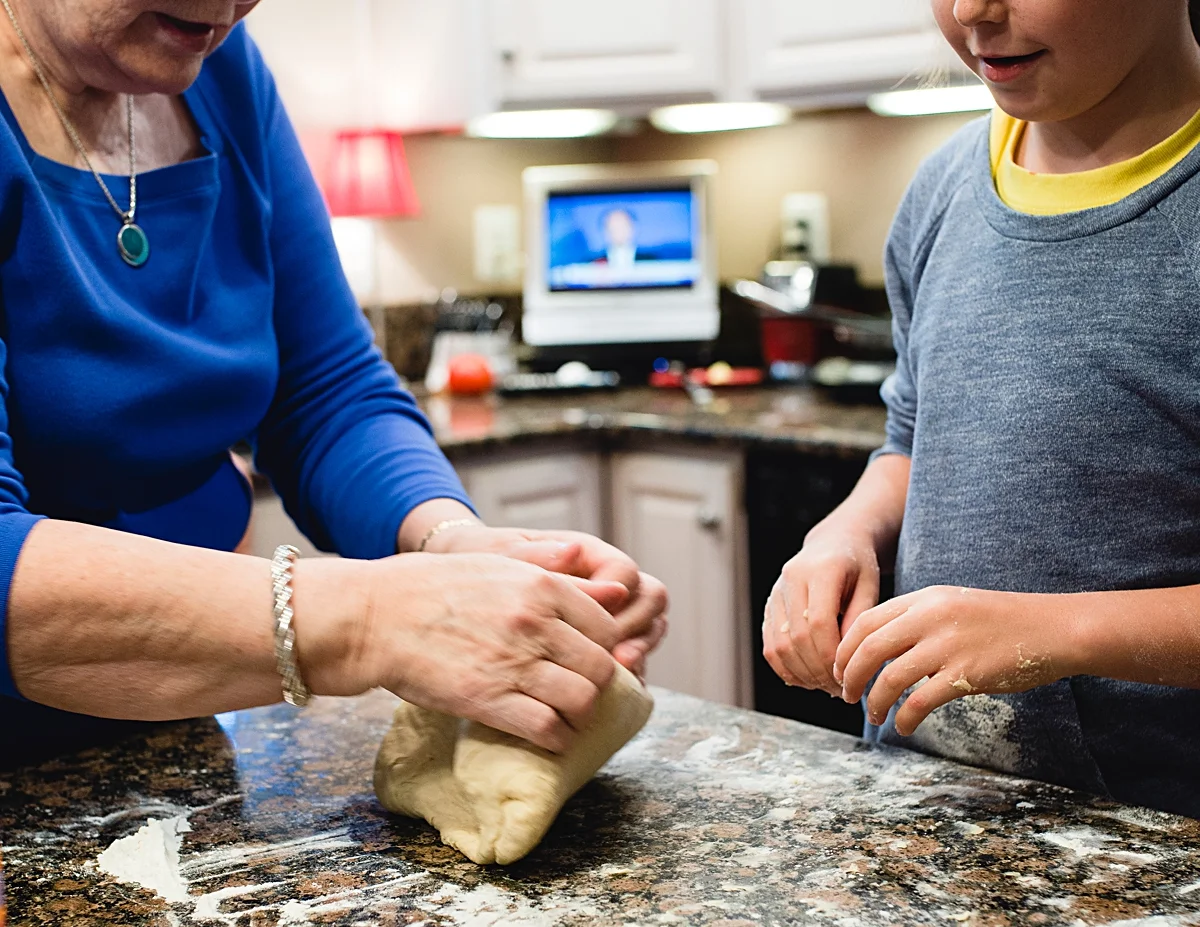 A grandmother teaches her granddaughter how to make Finnish Pulla bread. Photo by Denver Family Photographer, Kristiina Craven Photography.