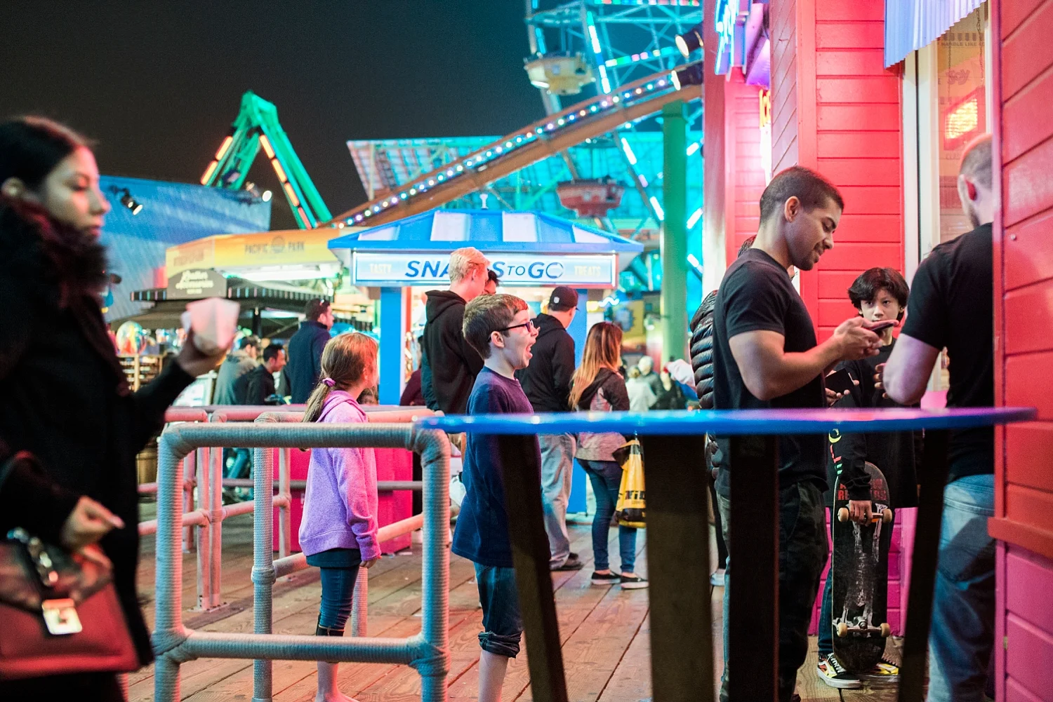 Tired kids, but not too tired to wait in line for dippin' dots at the Santa Monica Pier on our first roadschool trip together. | GettingUnschooled.com | #roadschooling #homeschooltravel #unschooling