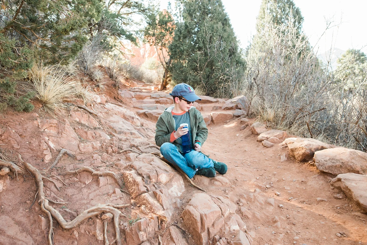 Townes takes a water break while hiking at the Garden of the Gods in Colorado Springs, Co. | GettingUnschooled.com | #unschooling #homeschooladventure #coloradodaytrip